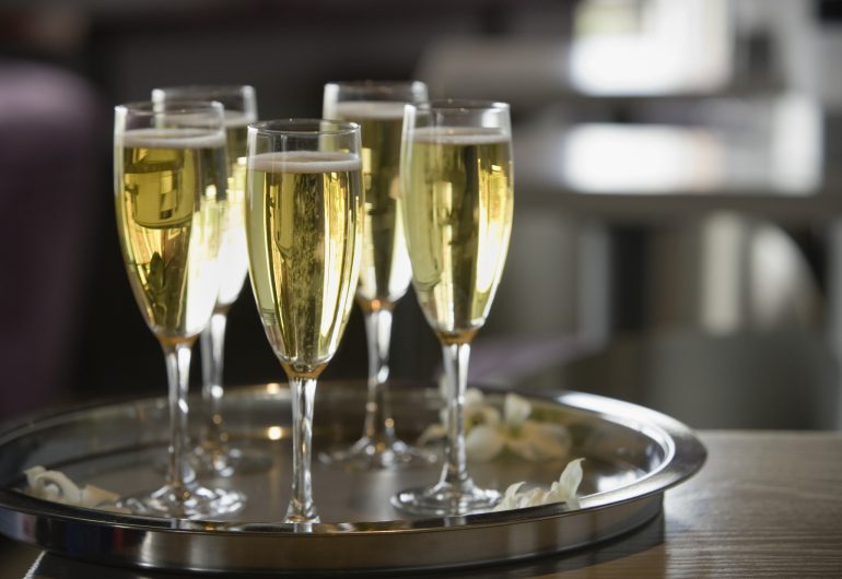 Glasses of champagne on a silver tray